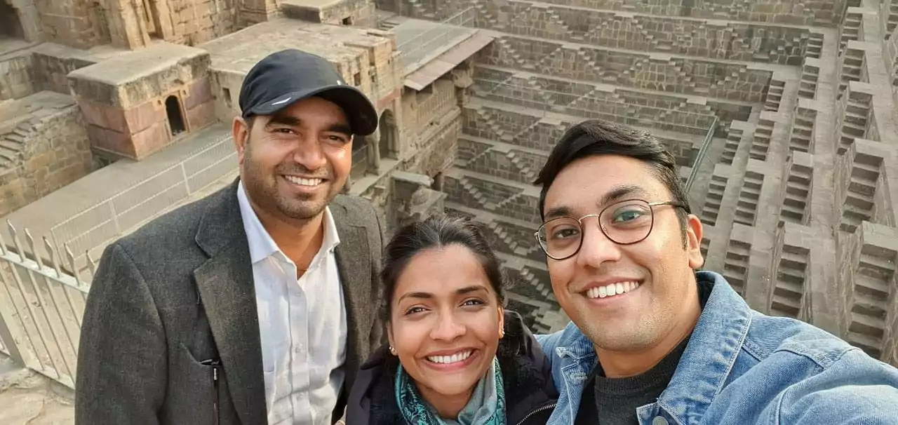 Namaste Private Driver India customers posing with their driver in Chand Baori